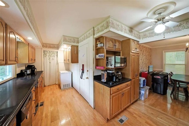 6880 Mark Turner Rd, Lithia Springs, GA 30122 - kitchen featuring stainless steel appliances, light wood-type flooring, dark countertops, crown molding, and ceiling fan