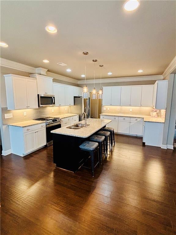 kitchen with white cabinetry, sink, and stainless steel appliances