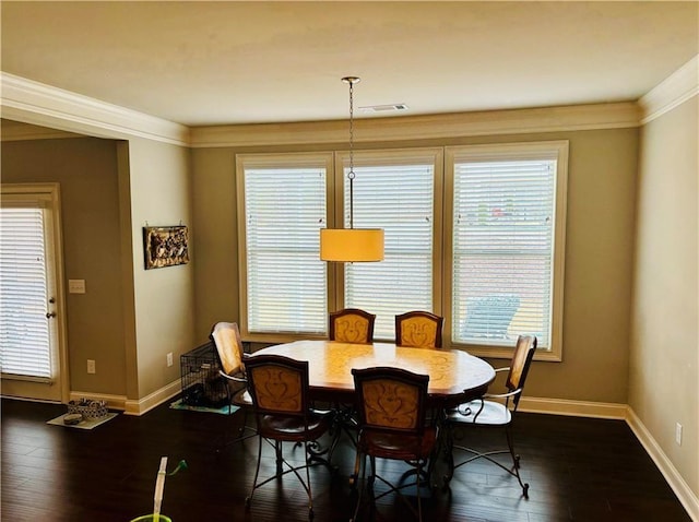 dining area with ornamental molding, a healthy amount of sunlight, and dark hardwood / wood-style floors