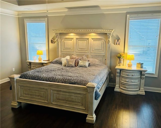 bedroom featuring crown molding and dark hardwood / wood-style floors