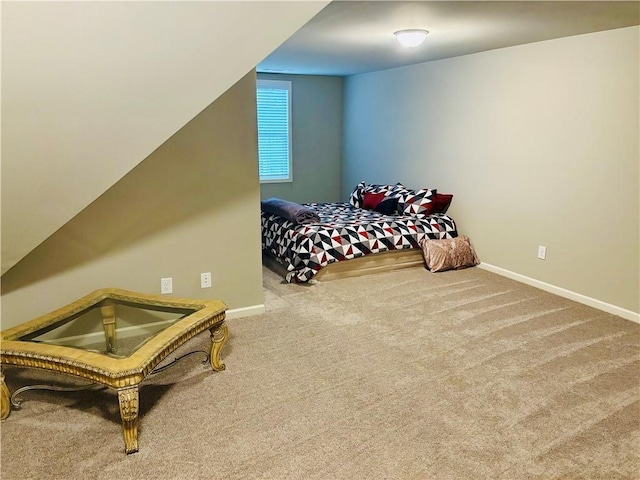 bedroom featuring vaulted ceiling and carpet floors