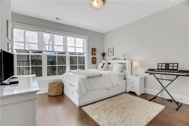 bedroom with dark wood-type flooring