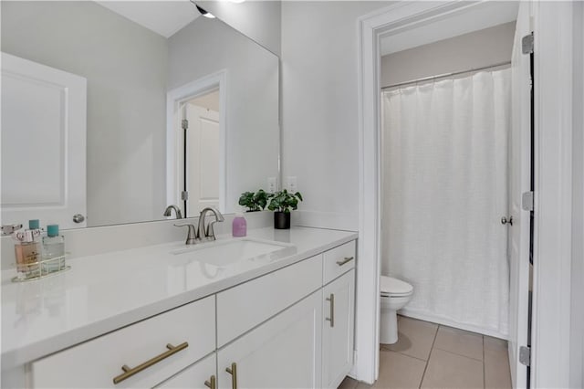 bathroom featuring toilet, vanity, and tile patterned floors