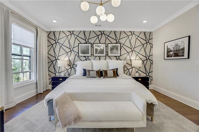 bedroom featuring dark wood-type flooring, crown molding, and a chandelier