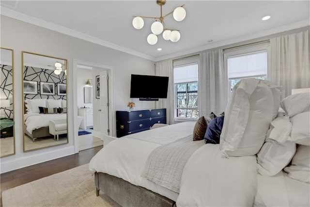 bedroom featuring ensuite bath, dark hardwood / wood-style floors, an inviting chandelier, and crown molding