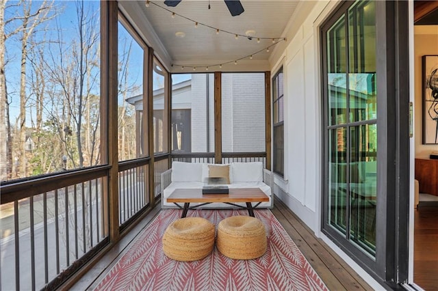 sunroom / solarium featuring ceiling fan