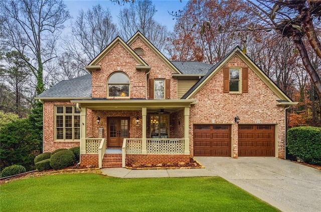 view of front of house with a front yard, a porch, and a garage