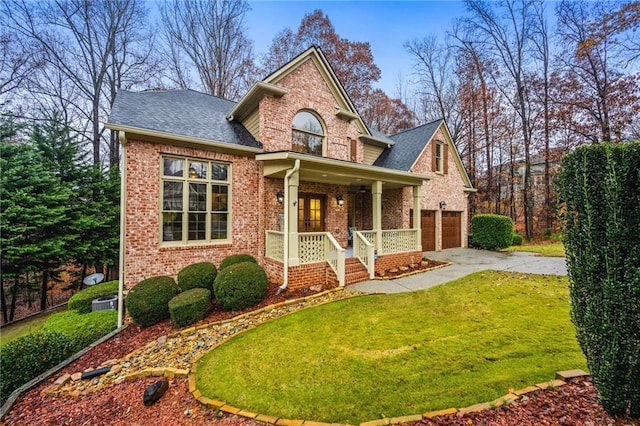 view of front of property with a garage, covered porch, and a front yard