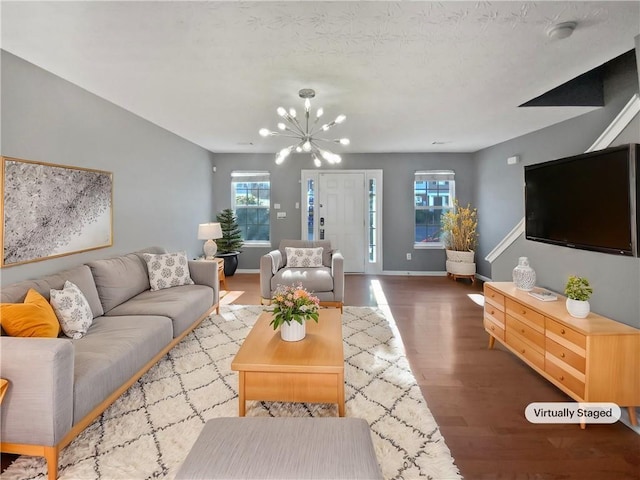 living room featuring hardwood / wood-style floors and a notable chandelier