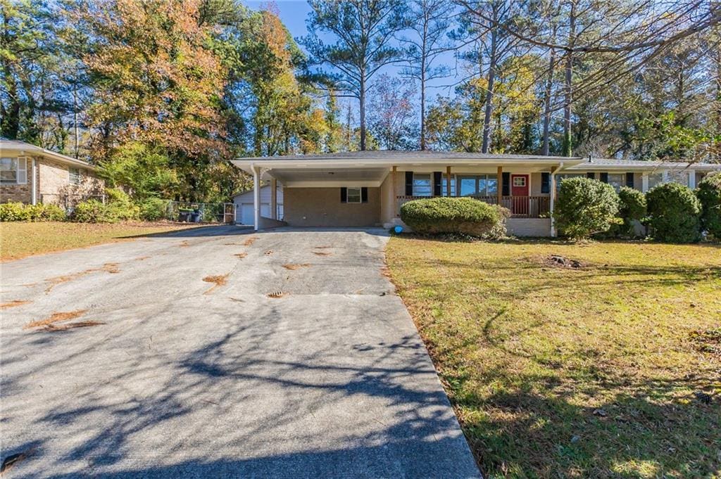6677 Songwood Dr, Austell, GA 30168 - ranch-style house with a front yard, an attached carport, and driveway