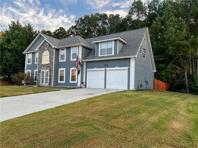 colonial inspired home with a front yard and a garage