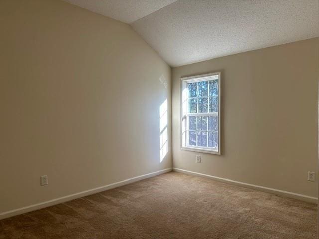 635 Beddick Ln, Atlanta, GA 30349 - carpeted spare room featuring lofted ceiling, baseboards, and a textured ceiling