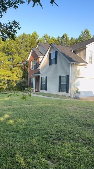 635 Beddick Ln, Atlanta, GA 30349 - back of house with a yard and a garage
