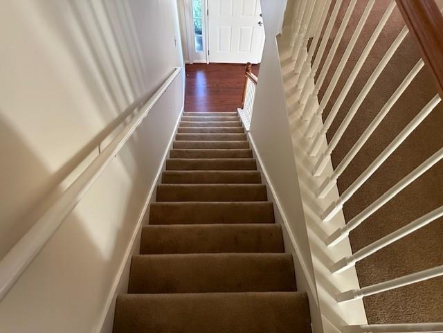 635 Beddick Ln, Atlanta, GA 30349 - stairway with wood finished floors