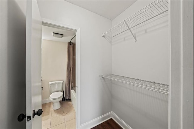 walk in closet with tile patterned floors