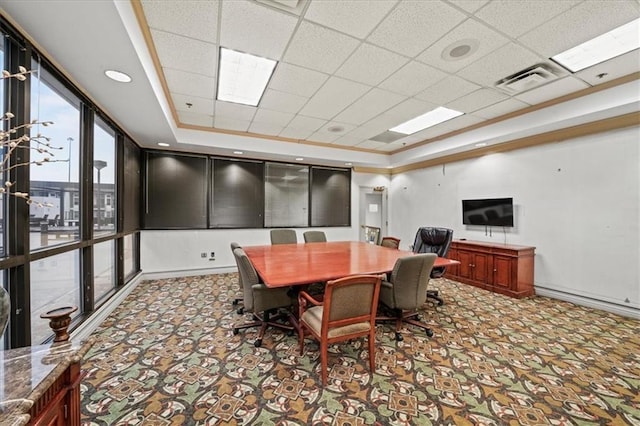 home office featuring a raised ceiling, light carpet, and a drop ceiling