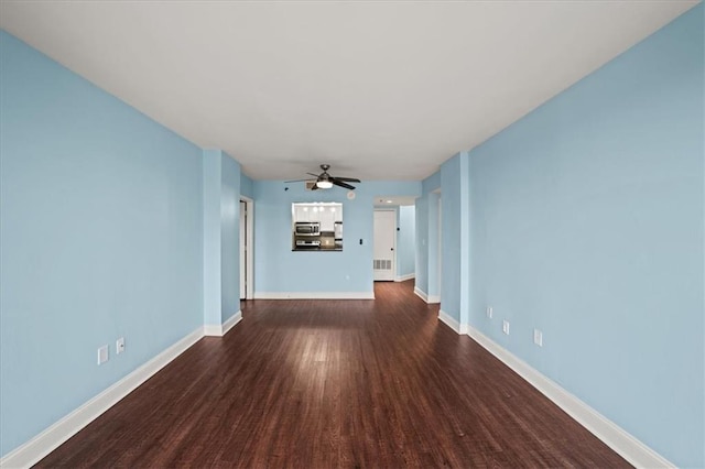 unfurnished living room featuring dark hardwood / wood-style floors and ceiling fan