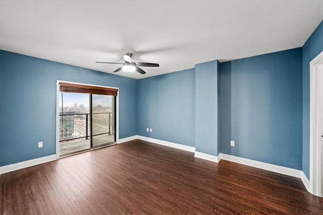 spare room with ceiling fan and dark hardwood / wood-style flooring