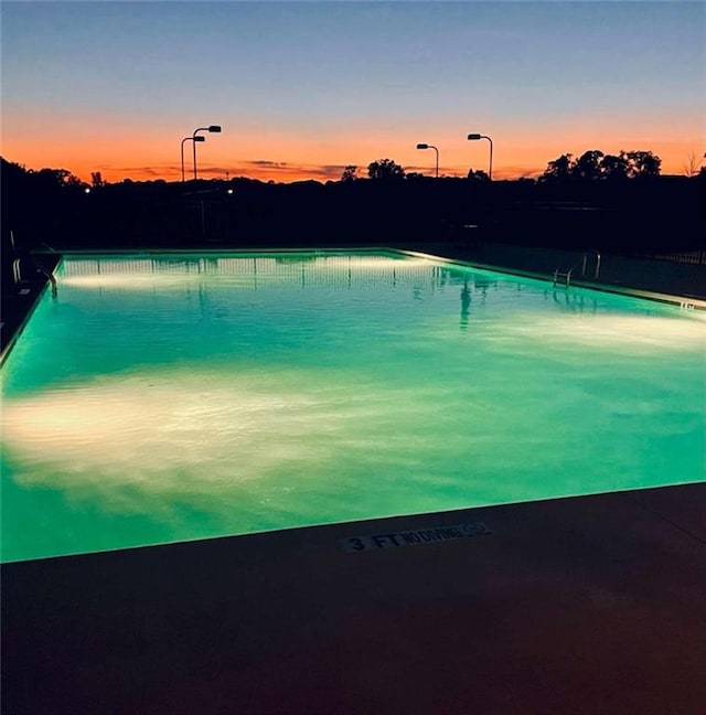 view of pool at dusk