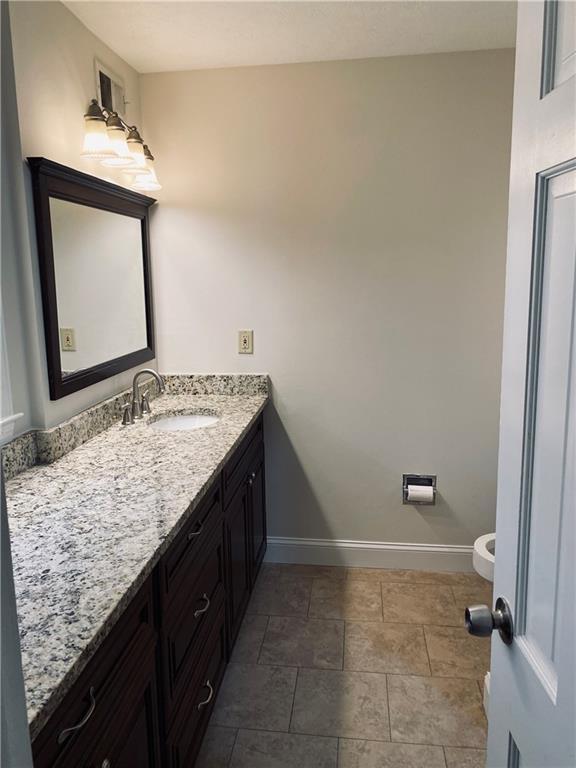 bathroom with vanity and baseboards