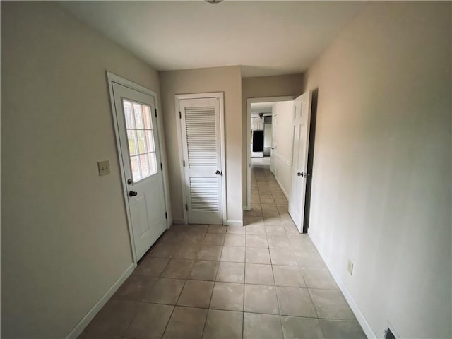 interior space featuring light tile patterned floors and baseboards