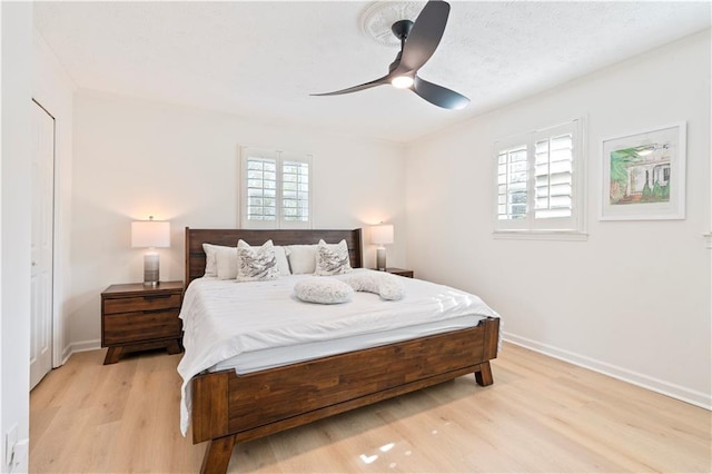 bedroom with light hardwood / wood-style flooring and ceiling fan