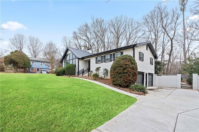 view of front of home with a garage and a front lawn