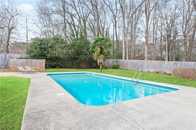 view of swimming pool featuring a yard and a patio