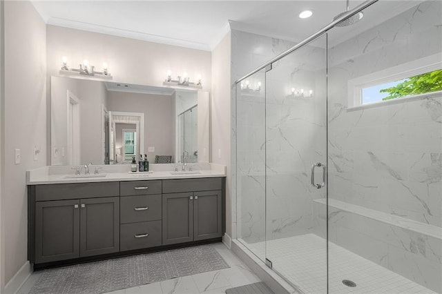 bathroom with a sink, a marble finish shower, marble finish floor, and crown molding