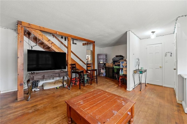 living room featuring hardwood / wood-style flooring and a textured ceiling