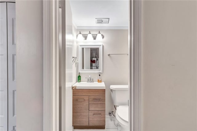 half bath with visible vents, crown molding, vanity, and toilet