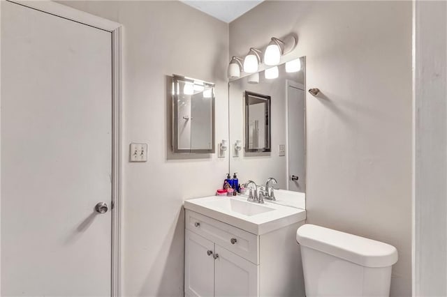 bathroom featuring toilet and vanity