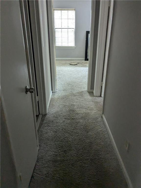 hallway with light colored carpet