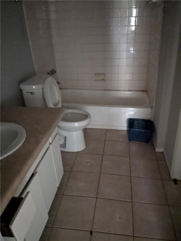 full bathroom featuring tile patterned flooring, vanity, toilet, and tiled shower / bath