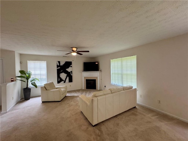 105 Avonwood Cir, Locust Grove, GA 30248 - living room with light carpet, a ceiling fan, a fireplace, and a textured ceiling