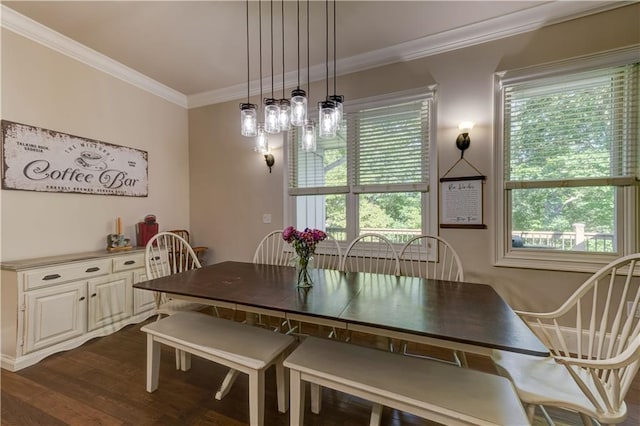 dining space featuring dark hardwood / wood-style flooring and crown molding