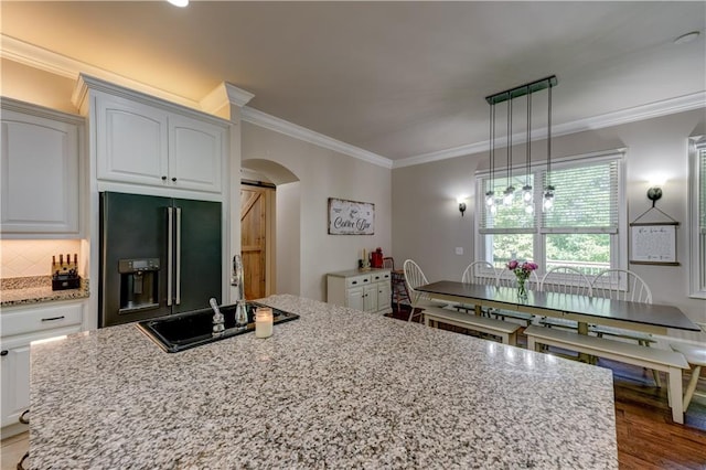 kitchen featuring white cabinetry, a barn door, pendant lighting, hardwood / wood-style flooring, and high end fridge