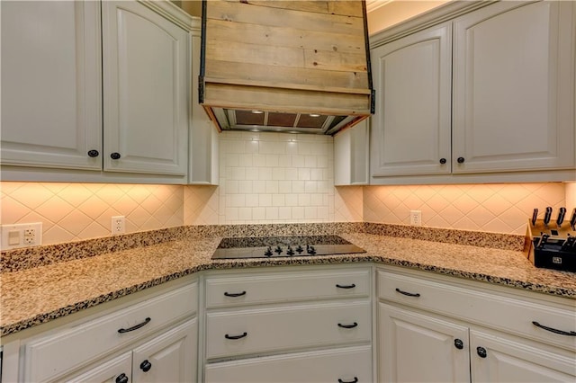 kitchen featuring white cabinets, custom range hood, decorative backsplash, and black electric stovetop