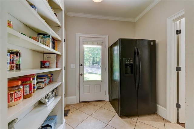 doorway to outside featuring light tile patterned flooring and crown molding