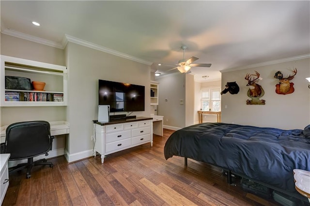 bedroom featuring ornamental molding, dark wood-type flooring, ceiling fan, and built in desk