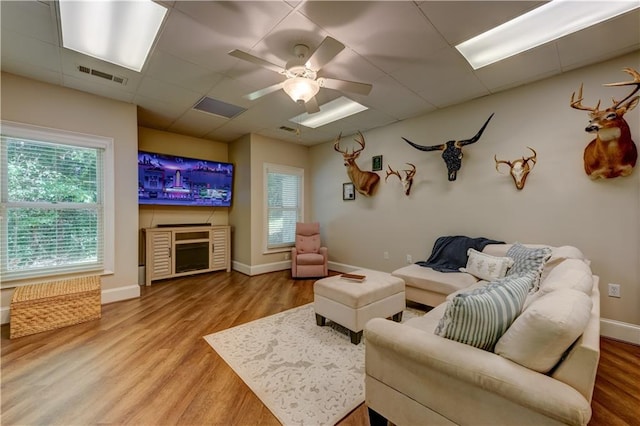 living room featuring a fireplace, hardwood / wood-style flooring, and ceiling fan