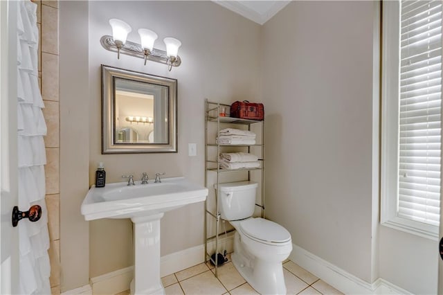 bathroom featuring tile patterned floors, toilet, sink, and ornamental molding