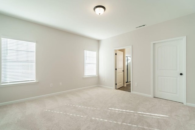 unfurnished bedroom with baseboards, visible vents, and carpet floors