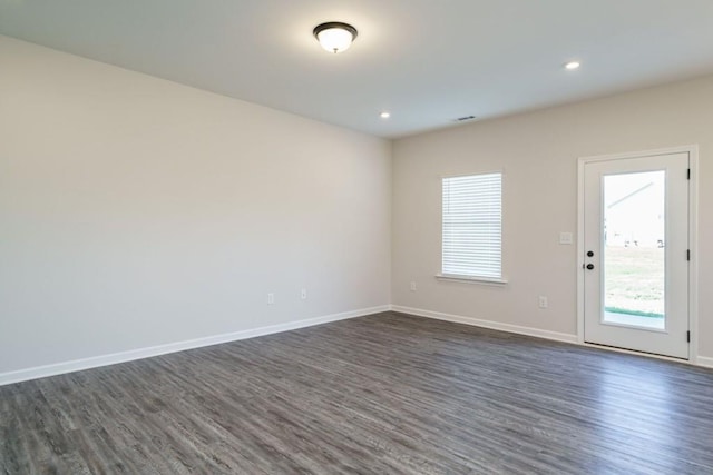 unfurnished room featuring recessed lighting, visible vents, baseboards, and dark wood-type flooring