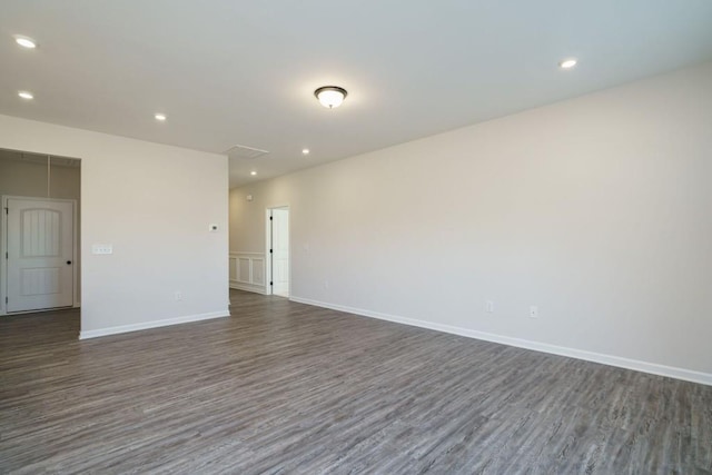 empty room featuring recessed lighting, baseboards, and wood finished floors