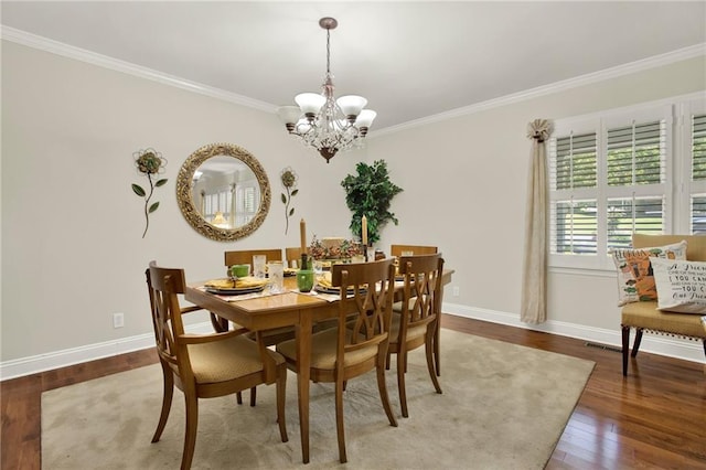 103 Mims Dr, Calhoun, GA 30701 - dining space with a chandelier, ornamental molding, baseboards, and wood-type flooring