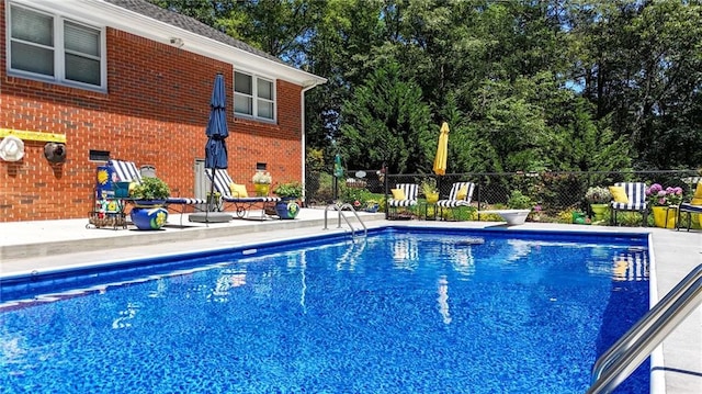 103 Mims Dr, Calhoun, GA 30701 - view of pool featuring a patio area, view of scattered trees, and a diving board