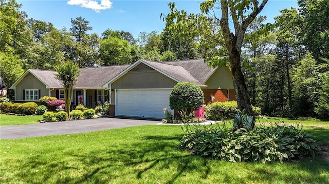 103 Mims Dr, Calhoun, GA 30701 - single story home with a front lawn, driveway, a garage, and brick siding