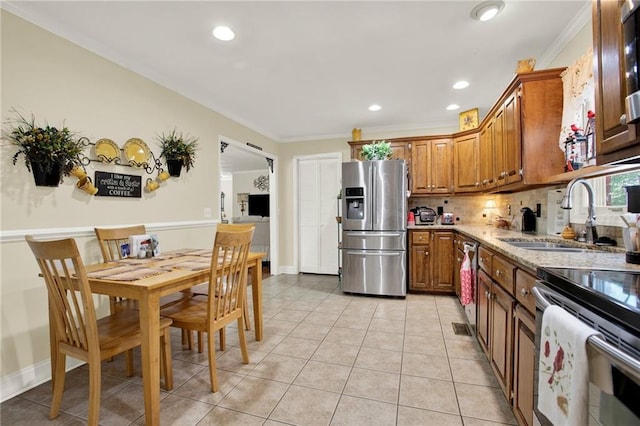 103 Mims Dr, Calhoun, GA 30701 - kitchen with stainless steel appliances, a sink, brown cabinets, ornamental molding, and light tile patterned floors