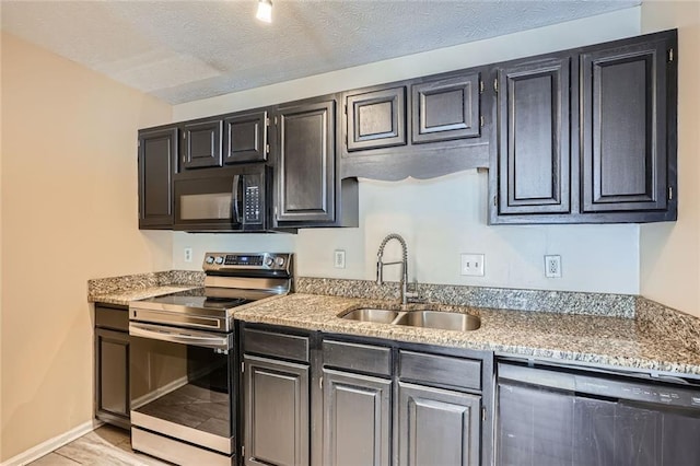 kitchen with dishwashing machine, a textured ceiling, electric stove, and a sink